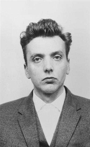 Black and white mugshot of Ian Brady.