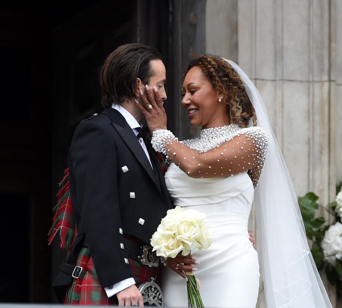 Mel B and Rory McPhee sharing a kiss after their wedding ceremony at St. Paul's Cathedral.