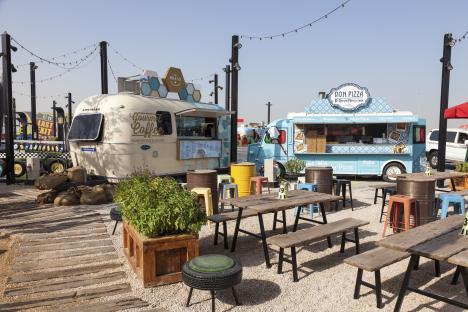 Last Exit food truck park with tables and chairs.