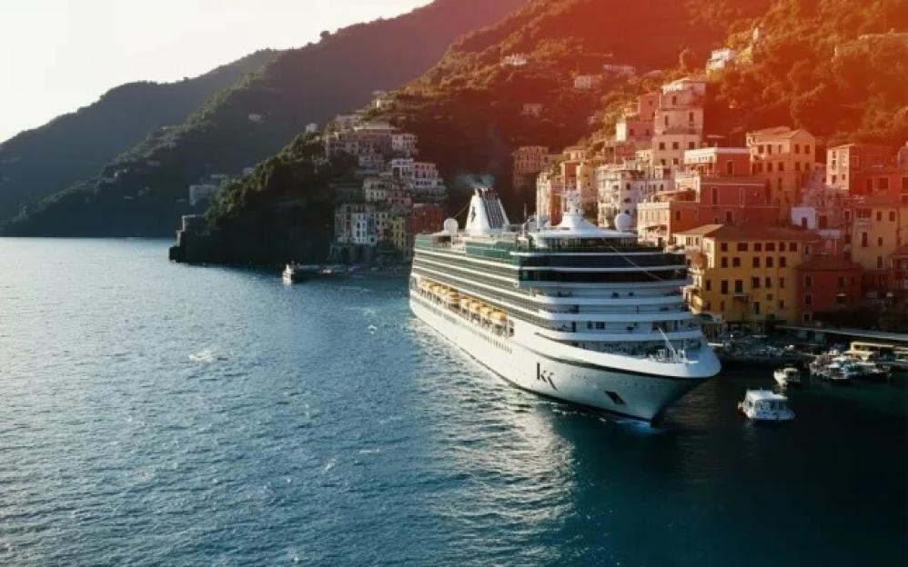 Cruise ship docked in a picturesque Italian town.