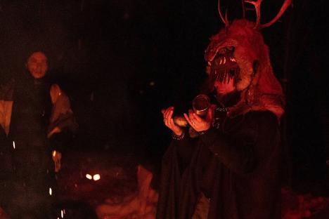 Police raid a nighttime forest ceremony.