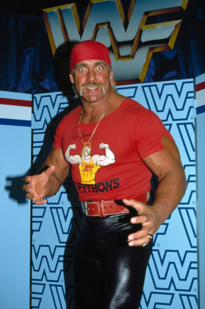 Hulk Hogan in a red t-shirt with his signature and image.