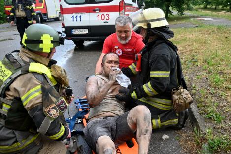 Injured man drinking water after being rescued from rubble in Kharkiv, Ukraine.