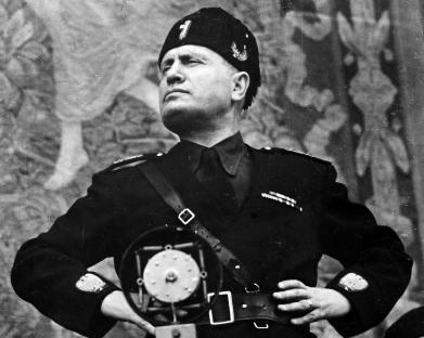 Black and white photo of Benito Mussolini in uniform.