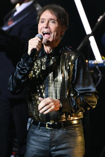 Sir Cliff Richard performing on stage.