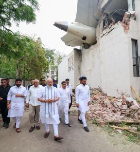 Prime Minister Narendra Modi visiting the site of an airplane crash.