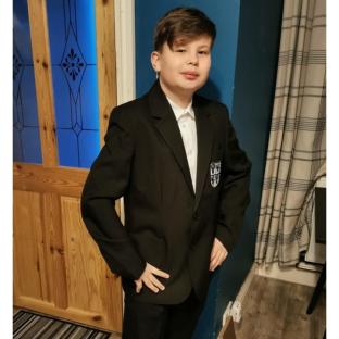 Photo of a boy in a school uniform.