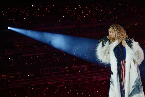 Beyoncé performing on stage at MetLife Stadium.