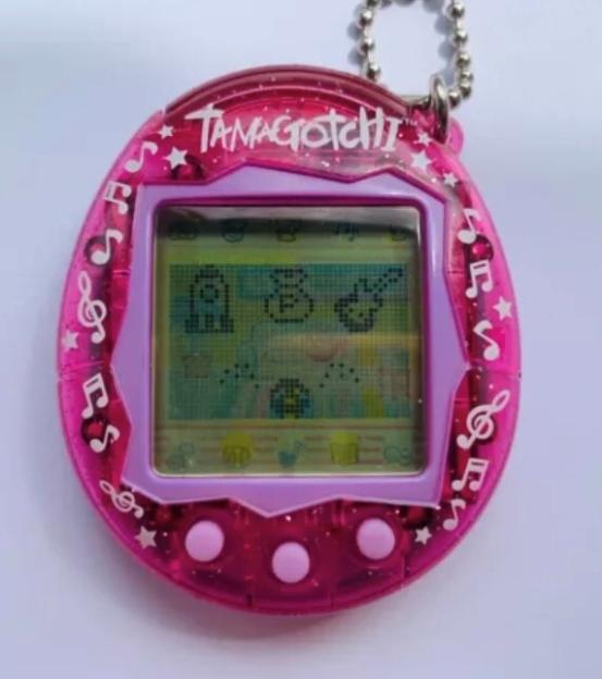 Pink Tamagotchi with musical notes and stars on the casing.