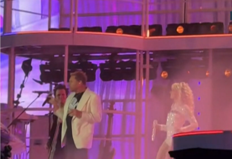 Sabrina Carpenter and a male musician performing on stage.