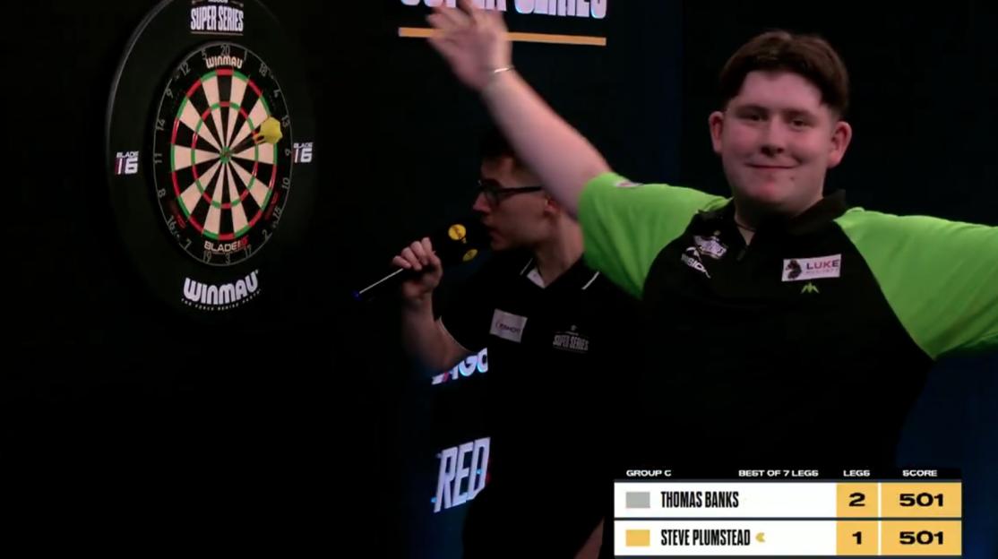 Darts player Thomas Banks celebrates a win.