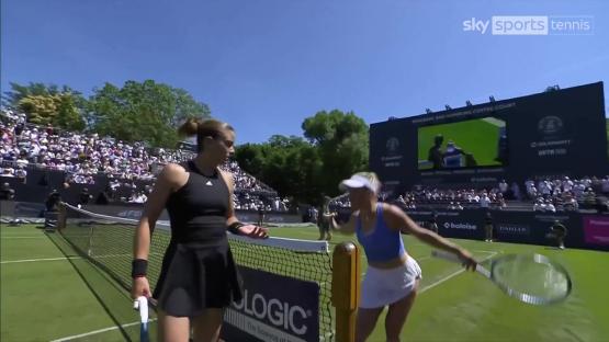 Maria Sakkari and Yulia Putintseva arguing on a tennis court.