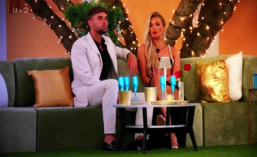 Harry and Helena from Love Island sitting on a couch.
