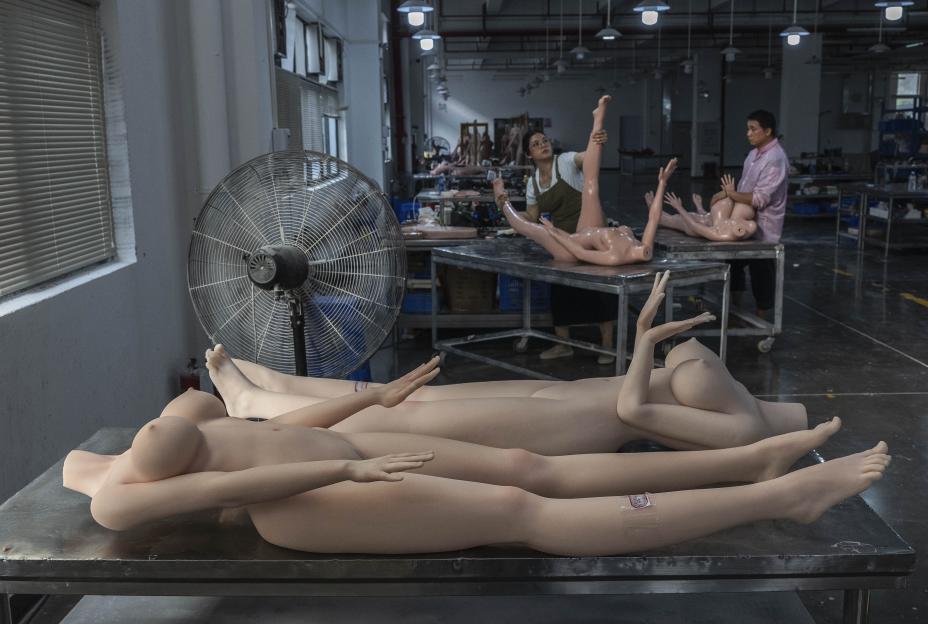 Workers assemble silicone sex dolls in a factory.