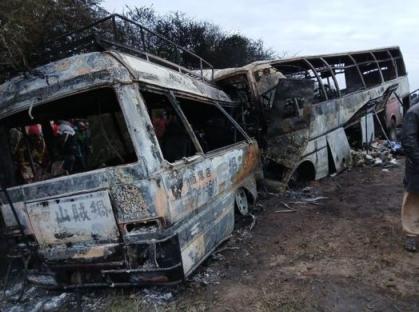 Burned-out buses after a fatal collision.