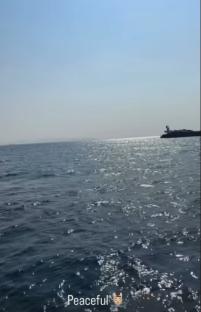Peaceful ocean scene with a distant structure.