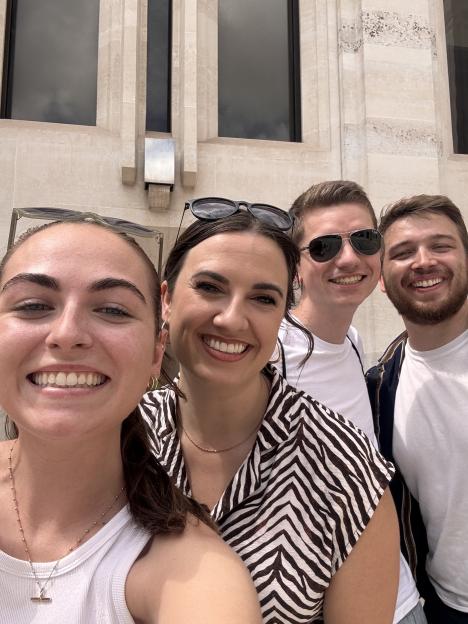 Four young adults smiling for a selfie.