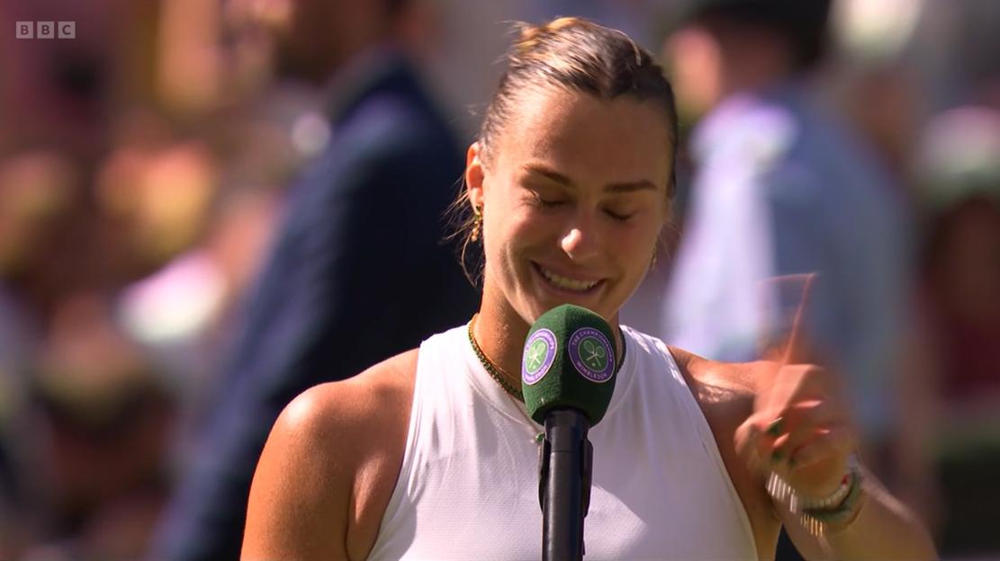 Aryna Sabalenka speaking into a Wimbledon microphone.