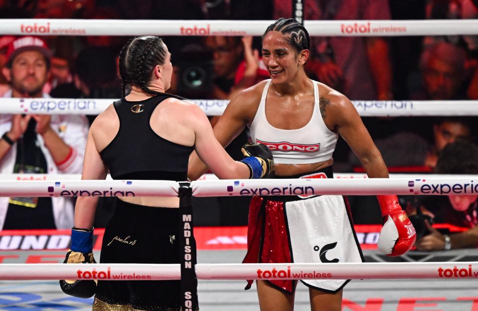 Katie Taylor and Amanda Serrano embracing after a boxing match.