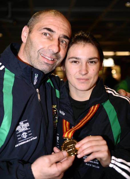 Katie Taylor with her father and trainer, holding her gold medal.