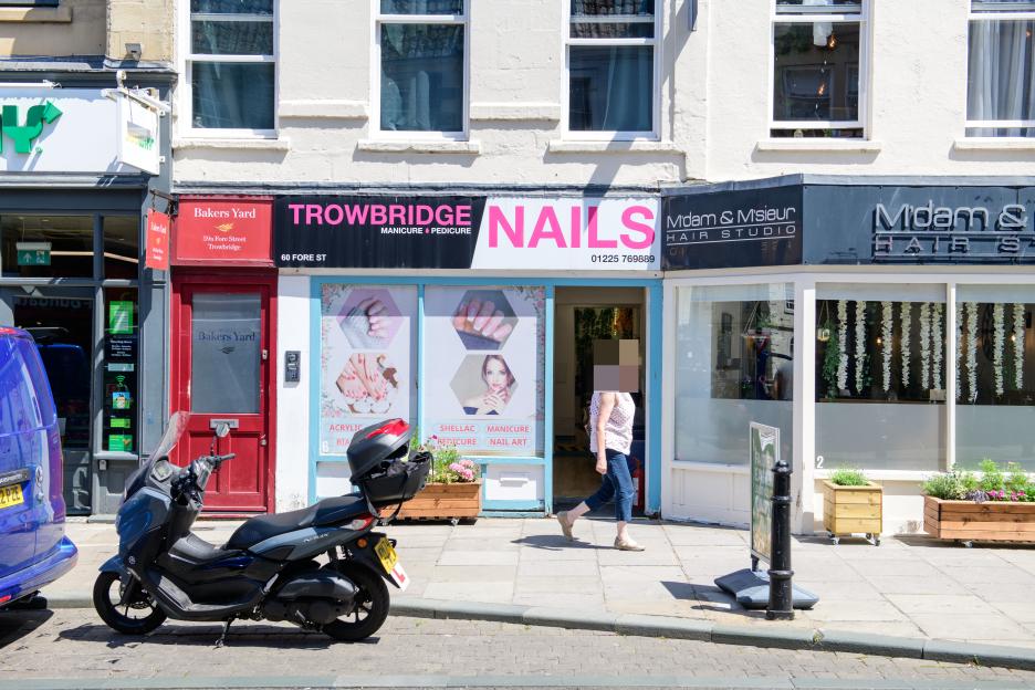 Trowbridge street scene with shops including a nail salon.
