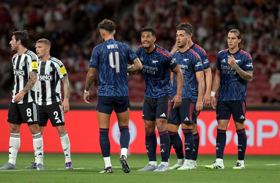 Arsenal players reacting during a soccer match.