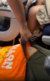 Person fastening seatbelt on another person.