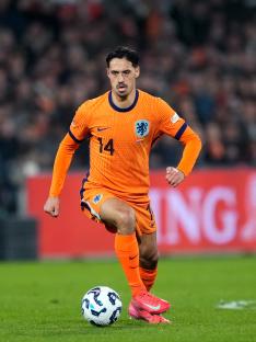 Tijjani Reijnders of the Netherlands national soccer team dribbling the ball.