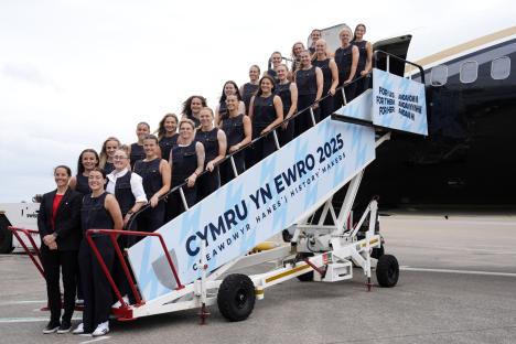 Wales Women's Euro 2025 squad boarding a plane.
