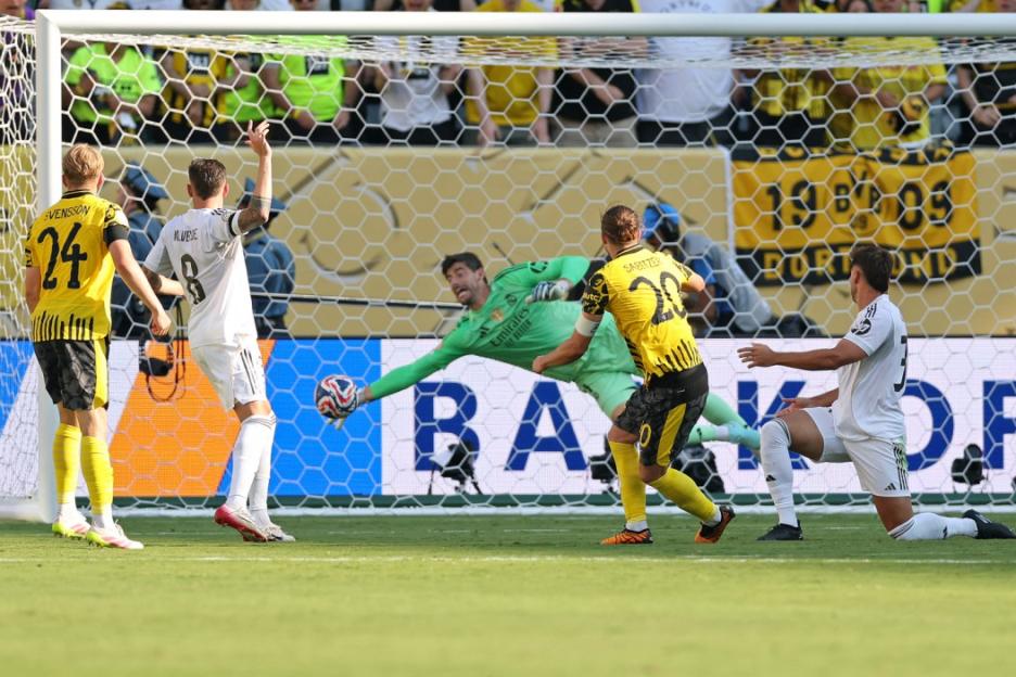 Real Madrid's Belgian goalkeeper #01 Thibaut Courtois (C) stops the ball as Borussia Dortmund's Austrian midfielder #20 Marcel Sabitzer shoots but fails to score during the FIFA Club World Cup 2025 quarterfinal football match between Spain's Real Madrid and Germany's Borussia Dortmund at the MetLife stadium in East Rutherford, New Jersey on July 5, 2025. (Photo by CHARLY TRIBALLEAU / AFP) (Photo by CHARLY TRIBALLEAU/AFP via Getty Images)