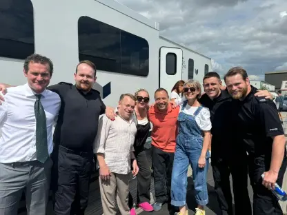 Group photo of film crew and police officers in front of a van.