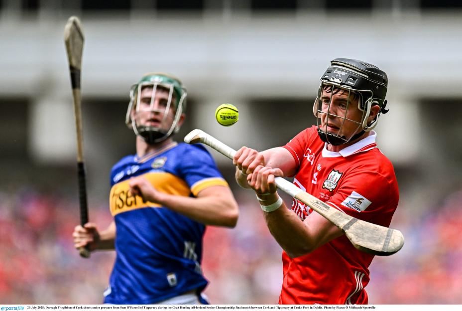Hurling player shoots the ball during a match.