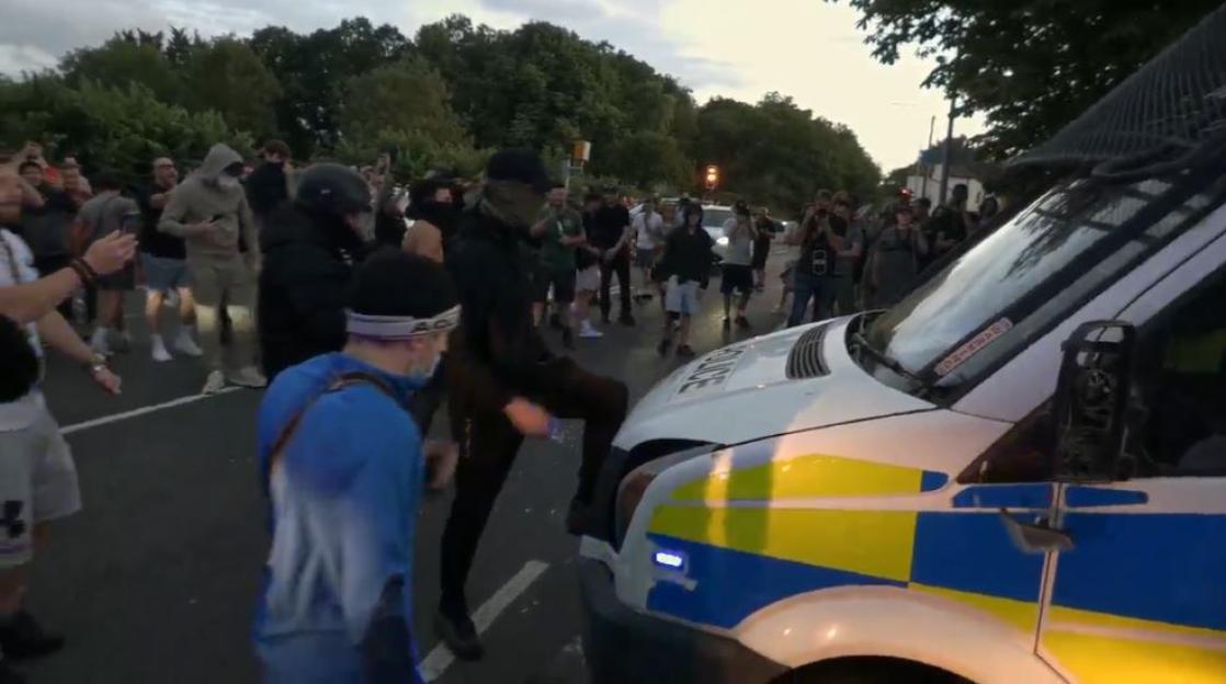 Riot police clash with protestors.