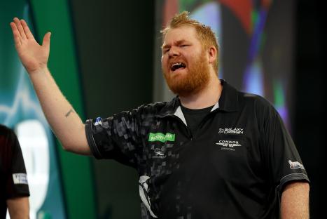 Matt Campbell reacting during a darts match.