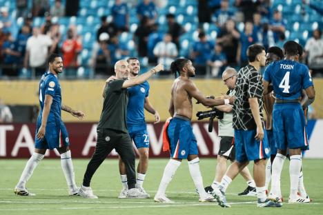 Chelsea's head coach Enzo Maresca celebrates a victory with his players.