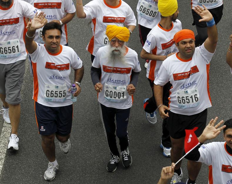Centenarian Fauja Singh, center, competing in a 10k race.