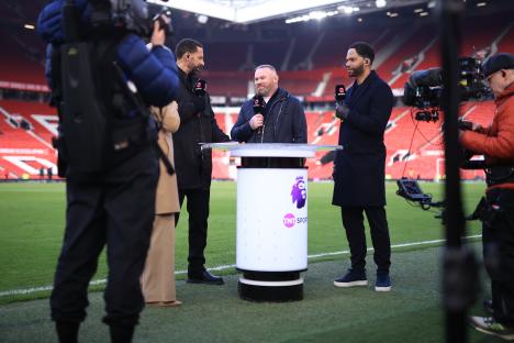 Wayne Rooney, Rio Ferdinand, and Joleon Lescott working as pundits for TNT Sports at a Premier League match.