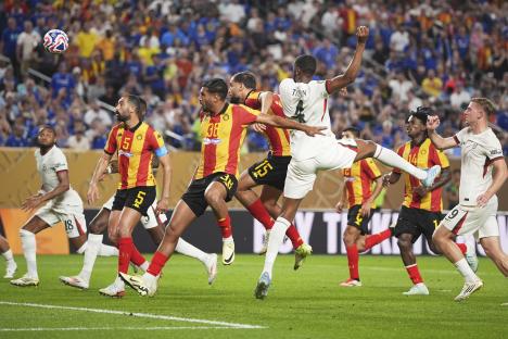 Soccer player heading the ball to score a goal.