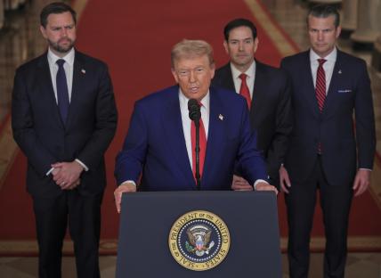 President Trump addressing the press with three other men.