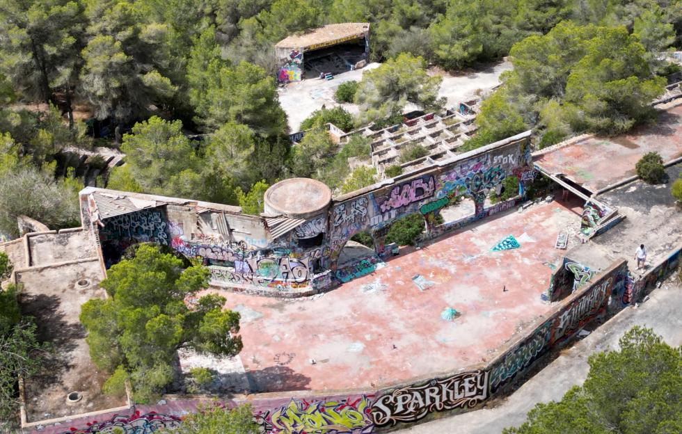 Aerial view of graffiti-covered ruins of a former Ibiza superclub.