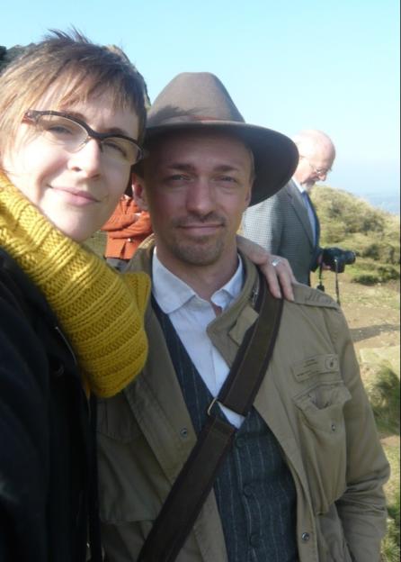 Couple posing for a selfie on a hilltop.