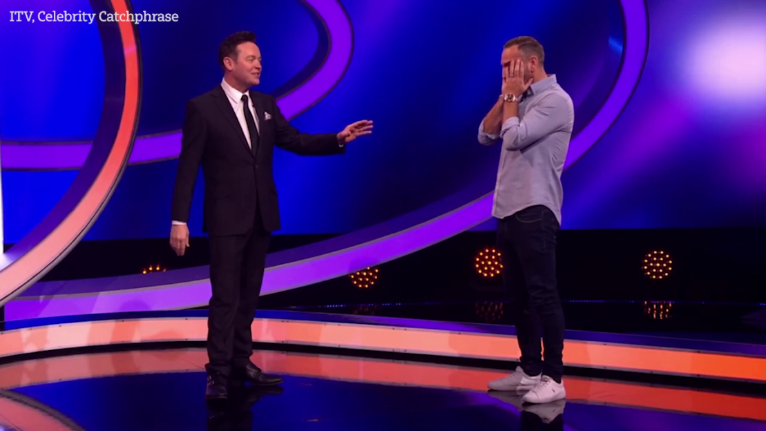 Screenshot of a game show featuring two men on stage.