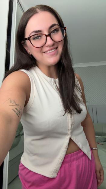 Woman smiling at the camera after breast reduction surgery.