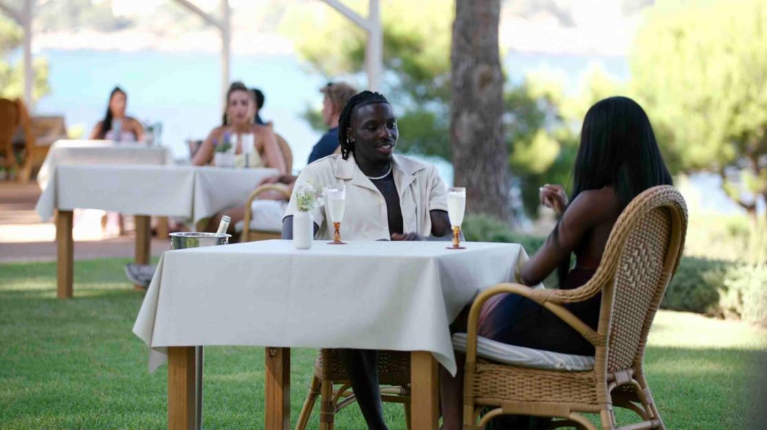 Two people on a date at an outdoor restaurant.