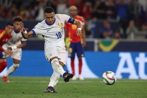 Kylian Mbappé taking a penalty kick.