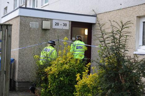 Two police officers at a murder scene.