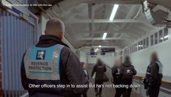 Revenue protection officer confronting fare dodgers.