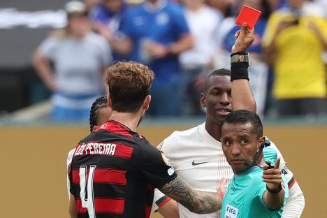 Referee showing a red card to a soccer player.