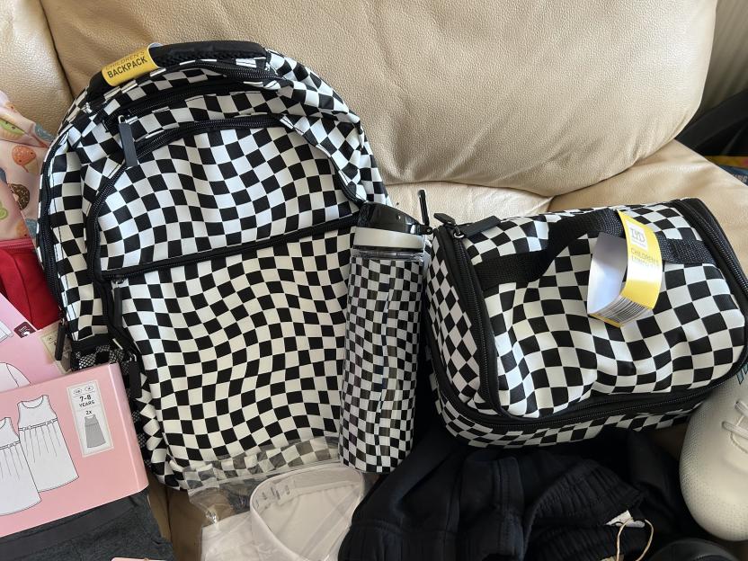 Black and white checkered backpack, lunch bag, and water bottle.