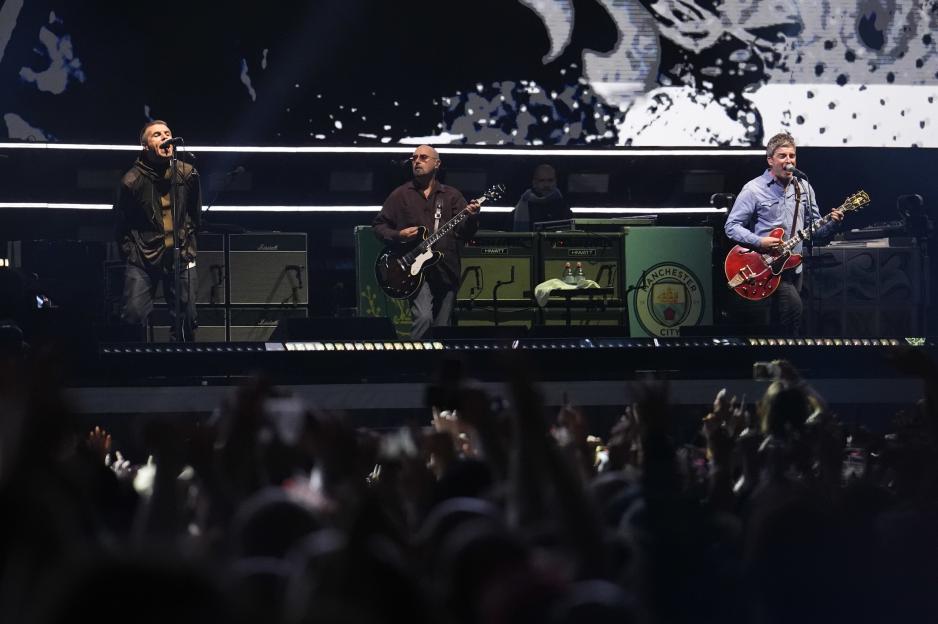 Oasis performing on stage.